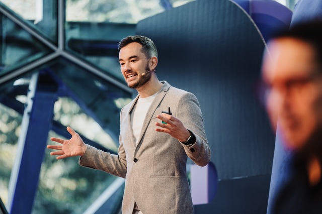 Jonathon Lau presenting on stage at DO23: Rediscover Creativity.